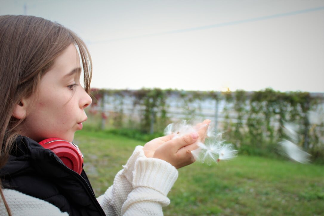 girl-blowing-feathers